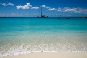 Blue waters blue sky with boats in the caribbean island of Anguilla