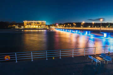 Fototapeta na wymiar Concrete pier in Kolobrzeg, long exposure shot at night
