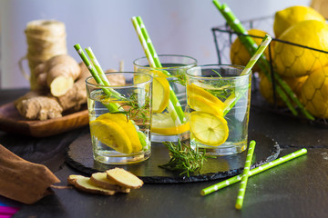 Ingredients for making flu fighting natural hot drink. Oranges, mint, lemons, ginger, honey, apple and spices over plywood background, top view, copy space. Clean eating, detox, dieting concept