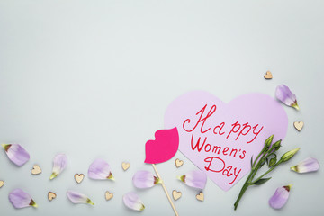 Inscription Happy Women's Day with flower petals on grey background