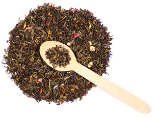 Leaf tea with flowers and fruits wooden spoon