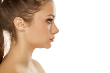 profile of young girl with makeup on white background