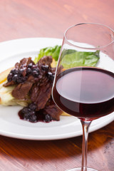 Glass of red wine and beef.