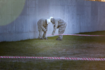 Workers in chemical protection suite are boarding contaminated zone