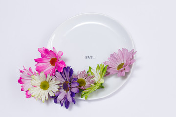 Obraz na płótnie Canvas Bright Flowers on Appetizer Plate
