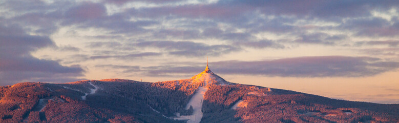 Morning sunrise at Jested Mountain and Jested Ski Resort. Winter time panorama. Liberec, Czech...