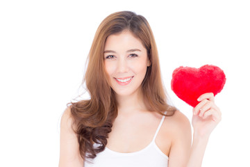 Obraz na płótnie Canvas Portrait of beautiful asian young woman holding red heart shape pillow and smile isolated on white background, valentines day, holiday concept.