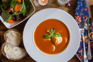 Tomato Bisque with Boiled Egg and Basil Garnish. High angle View