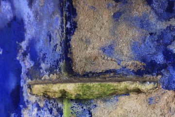 Colorful texture in an old blue painted wall