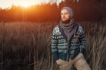 portrait of a bearded hipster tourist man in the woods forest