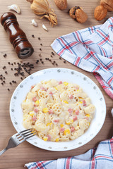 Italian wagon wheel shape pasta with ham and corn