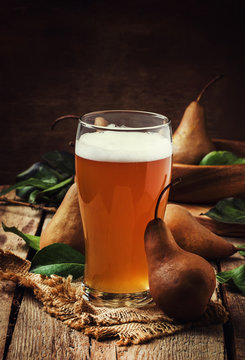 Spicy homemade cider of autumn brown pears, vintage wooden background, rustic style, selective focus