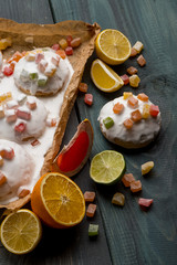 Homemade cookie with fruits and white chocolate glaze on wooden background copy text.