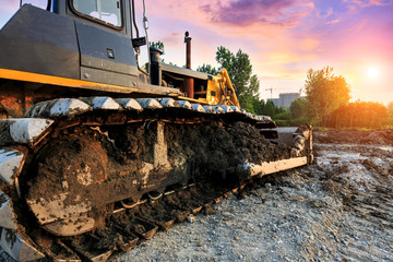 bulldozer at construction site and sunrise landscape © ABCDstock