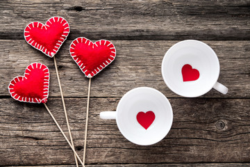 Plakat Valentines day background. Red hearts, ribbon and cup on wood background.