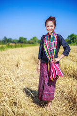 beautiful farmer woman with the straw in field