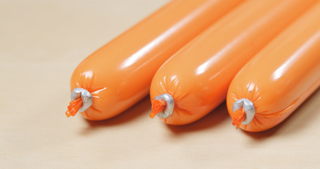 Snack sausage with plastic wrapping