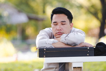 Asian business man working failing serious in the park