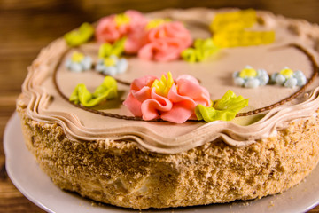 Kiev cake with cream on wooden table