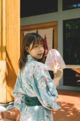 Lifestyle series: Asian woman in yukata holding paper fan