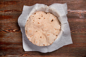Naan's flat cake, on a wooden table