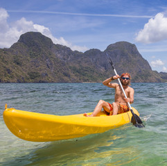 Young people rowing in kayak