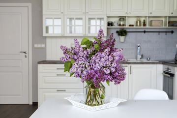 bouquet of purple lilac  on a table in the kitchen