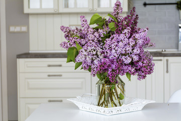 bouquet of purple lilac  on a table in the kitchen