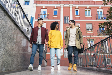 Obraz premium Group of happy friends walking in the street. Friendship concept.