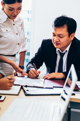 Discussing plan and idea to improvement strategy, businessmen brainstorming for strategy of business investment,businessmen review chart and document of investment information.