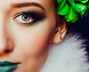 Close-up face of a person with green make-up
