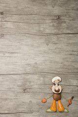 Naklejka premium Chef made with vegetables in the corner of wooden background