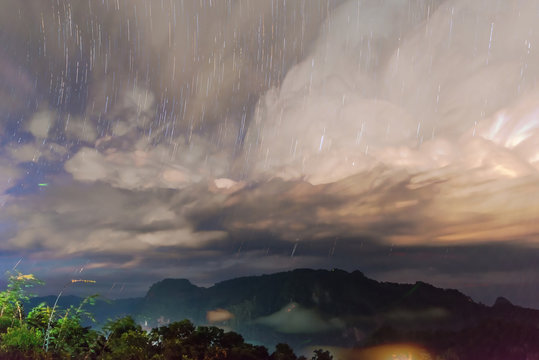 Startrail with Mountain view with foggy environment