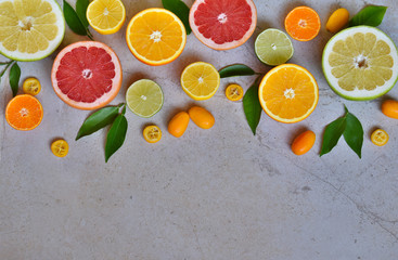 Set of citrus on light background: orange, mandarin, lemon, grapefruit, lime, kumquat, tangerine. Fresh organic juicy fruits. Source of vitamin C. Healthy food concept. Copy space