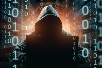 Hacker in the hood, hacker attack, silhouette of the man, mixed media. The concept of a sudden...