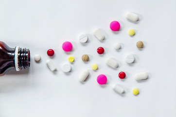 Top view of the pills on the white background, The drug and capsule pills on the floor, Pile of the drug and pills on the white background.
