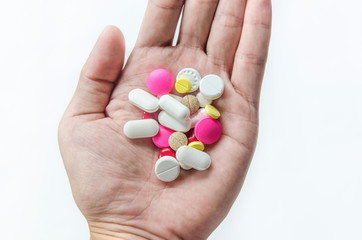 Top view of the pills on the hand and white background, A hand hold the pills and drug, Pile of the drug and pills on the hand.
