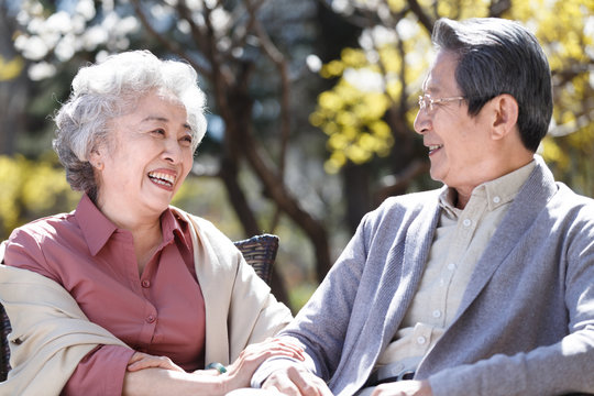 The elderly couple are outdoors