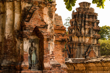 Ancient buddha statue in archaeological site at Wat Mahathat temple . old sculpture in history is a world heritage .