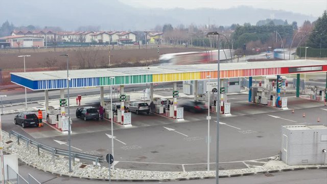 Time-lapse shot of a gas station as traffic moves by quickly
