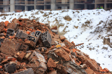 A pile of construction debris is broken brick and concrete.