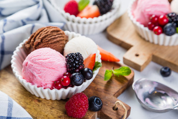 Selection of colorful ice cream scoops in white bowls