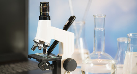 Science laboratory research and development concept. microscope with test tubes