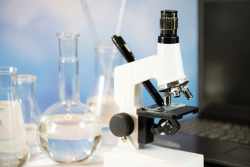 Science laboratory research and development concept. microscope with test tubes