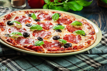 Pizza pepperoni with olives served