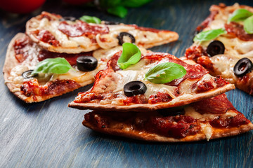 Slices of pizza pepperoni with olives
