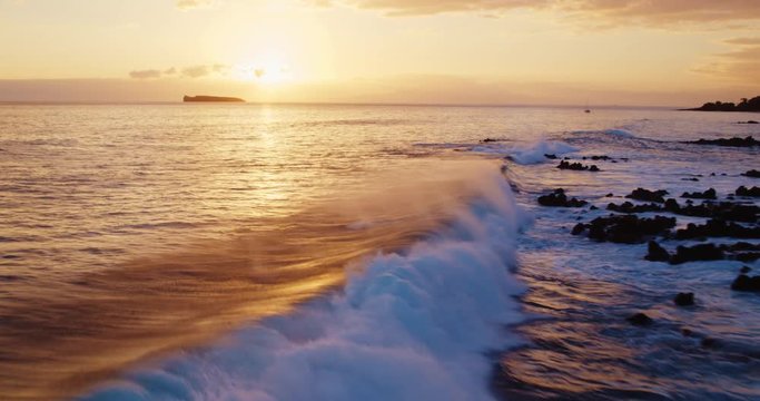 Cinematic aerial view of sunset waves