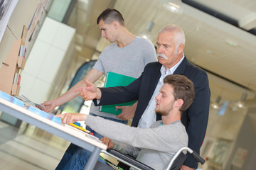 Obraz premium Teacher advising student in wheelchair