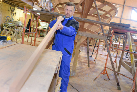 carpenter doing his job in carpentry workshop
