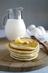 Country Breakfast, pancakes, milk and eggs. A rustic style.